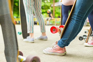 Image showing Teenage girl practicing riding long board.