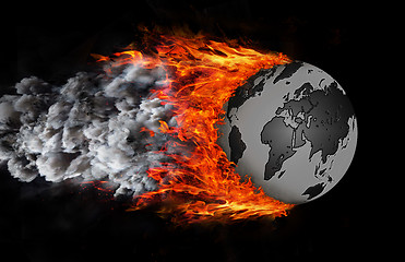 Image showing World with a trail of fire and smoke - globe