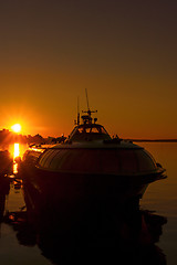 Image showing Silhouette of ship in city port on sunset