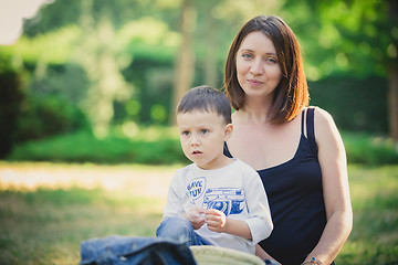 Image showing Mother and son in the park summer day.