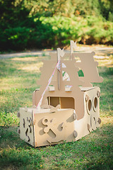 Image showing Cardboard toy boat in the park.