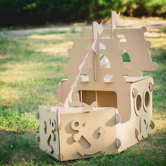 Image showing Cardboard toy boat in the park.