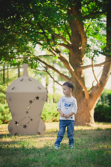 Image showing child playing in a cardboard spaceship. Eco concept