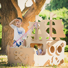 Image showing Boy and girl playing in a cardboard boat