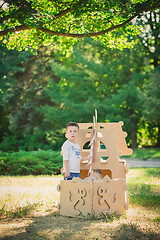 Image showing Boy and girl playing in a cardboard boat