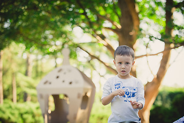 Image showing child playing in a cardboard spaceship. Eco concept