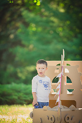 Image showing boy plaing in a cardboard boat