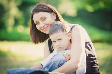 Image showing Mother and son in the park summer day.