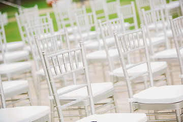 Image showing Prior to a wedding ceremony, endless white chairs 