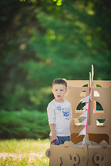 Image showing boy plaing in a cardboard boat