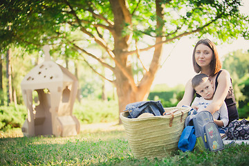 Image showing Mother and son in the park summer day.