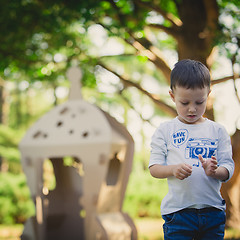 Image showing child playing in a cardboard spaceship. Eco concept