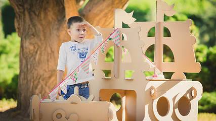 Image showing boy plaing in a cardboard boat