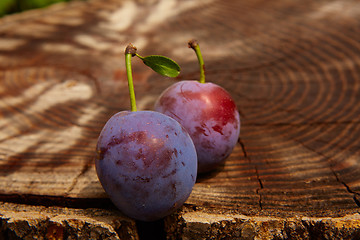 Image showing fresh plums on wooden table