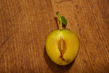 Image showing fresh plums on wooden table