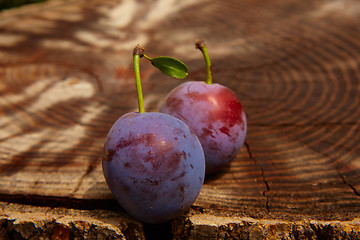 Image showing fresh plums on wooden table