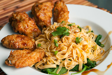 Image showing Chicken Wings with Noodles and Spinach