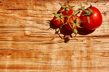 Image showing Fresh tomatoes with on wooden table