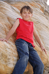 Image showing Child standing by a rockface