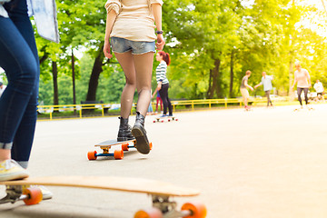 Image showing Teenage girl urban long board riding.