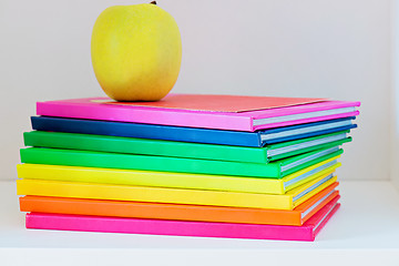 Image showing Apple sitting on top of a stack of school books