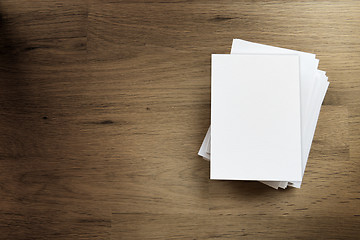 Image showing Blank paper card on wooden table