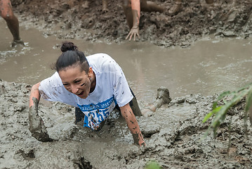 Image showing Attractive girl in extrime racing in mud hole