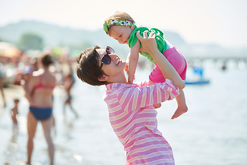 Image showing mom and baby on beach  have fun