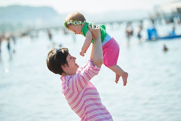 Image showing mom and baby on beach  have fun