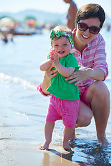 Image showing mom and baby on beach  have fun