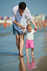 Image showing mom and baby on beach  have fun