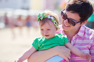 Image showing mom and baby on beach  have fun