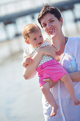 Image showing mom and baby on beach  have fun