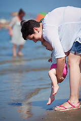 Image showing mom and baby on beach  have fun