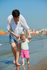 Image showing mom and baby on beach  have fun