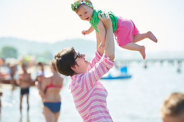 Image showing mom and baby on beach  have fun