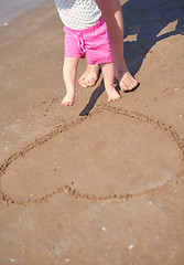 Image showing mom and baby on beach  have fun