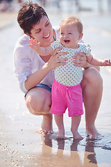 Image showing mom and baby on beach  have fun