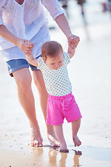 Image showing mom and baby on beach  have fun