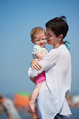 Image showing mom and baby on beach  have fun