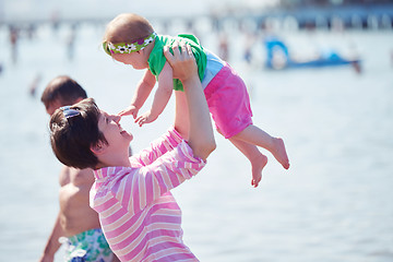 Image showing mom and baby on beach  have fun