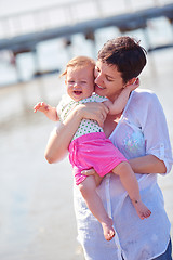 Image showing mom and baby on beach  have fun