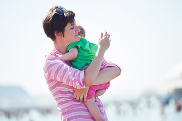 Image showing mom and baby on beach  have fun