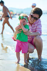 Image showing mom and baby on beach  have fun