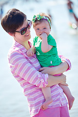 Image showing mom and baby on beach  have fun