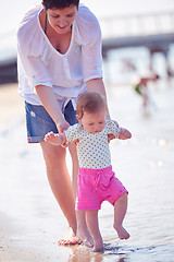 Image showing mom and baby on beach  have fun