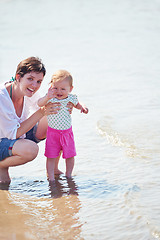 Image showing mom and baby on beach  have fun