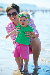 Image showing mom and baby on beach  have fun