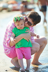 Image showing mom and baby on beach  have fun