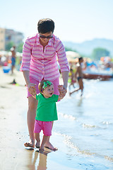 Image showing mom and baby on beach  have fun